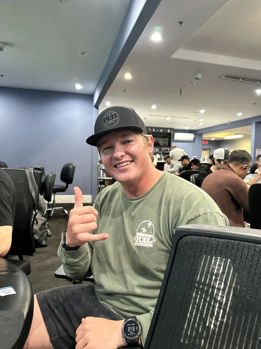 PLO Show fan in the black snapback throwing a shaka at the poker room